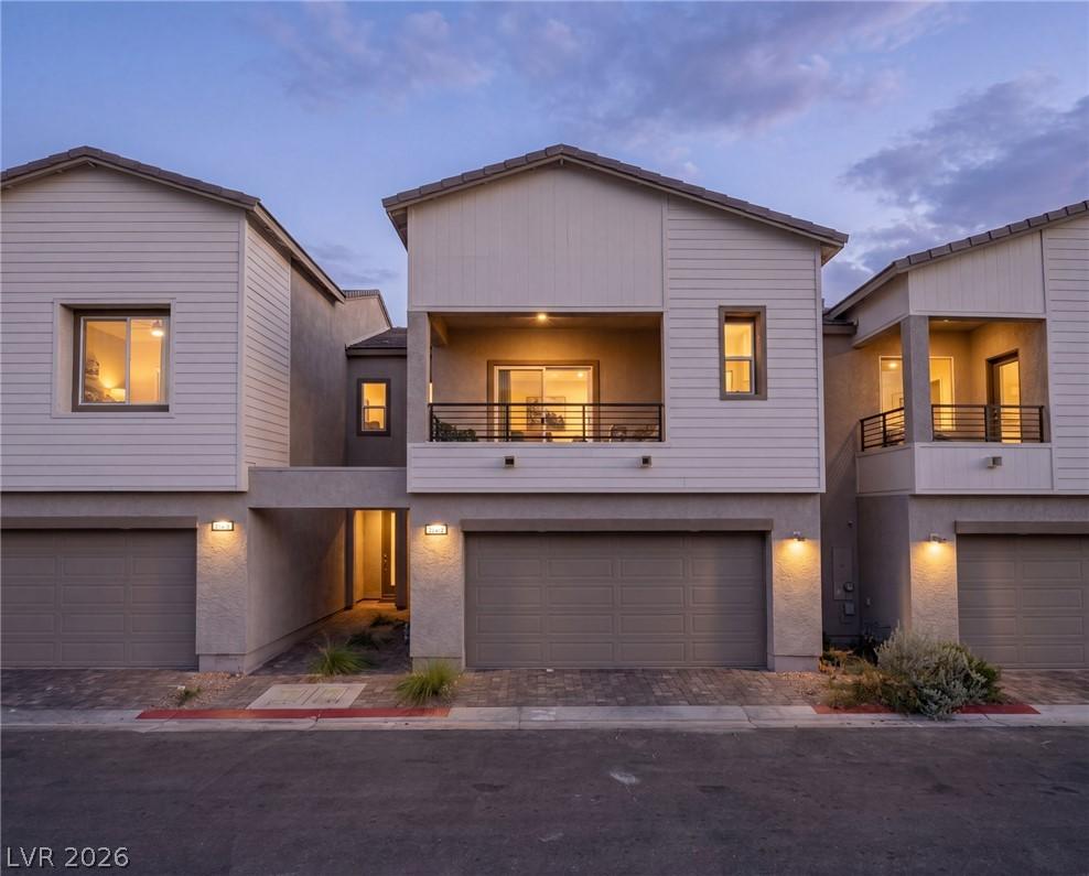 Image 1: Modern townhomes showcasing private garages and se