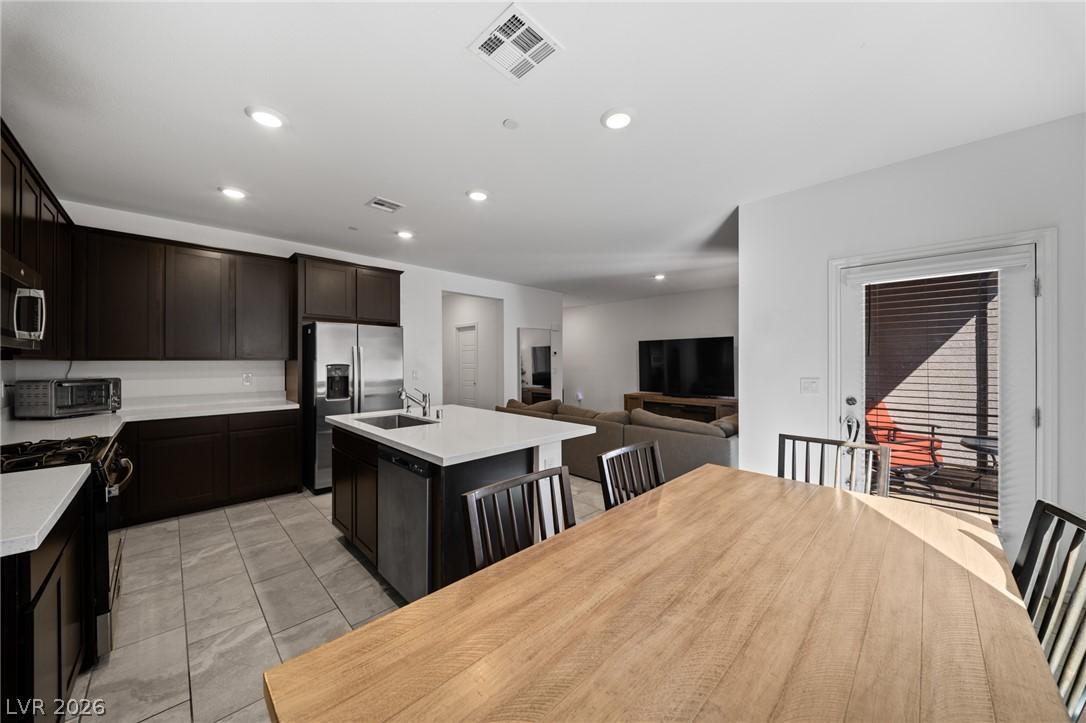Image 2: An open concept kitchen features abundant cabinetr