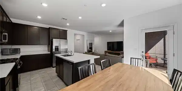 Image 2: An open concept kitchen features abundant cabinetr