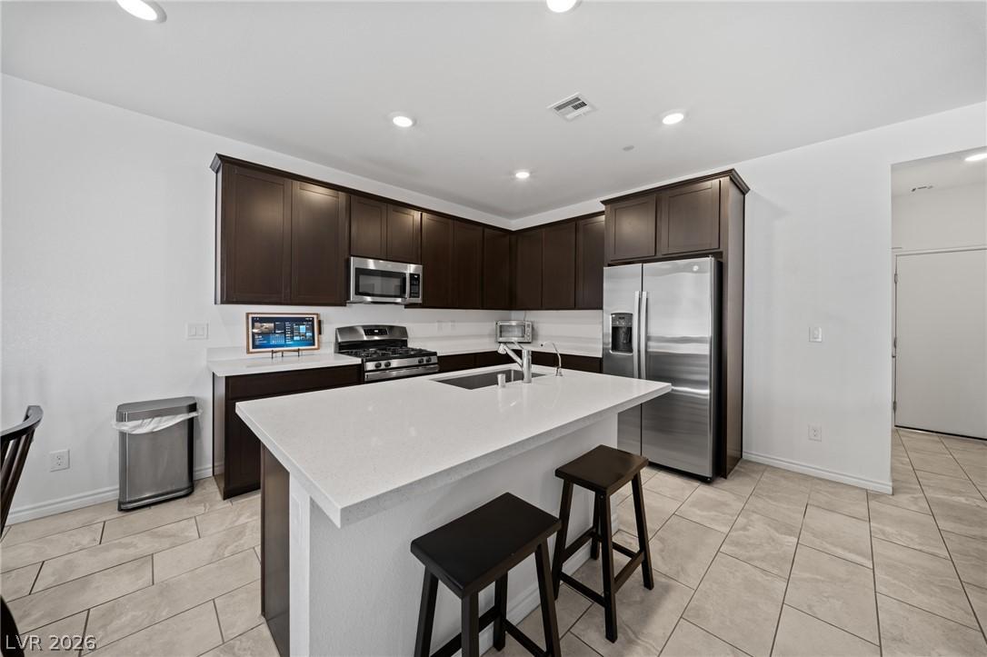 Image 4: Modern kitchen with white quartz countertops and a