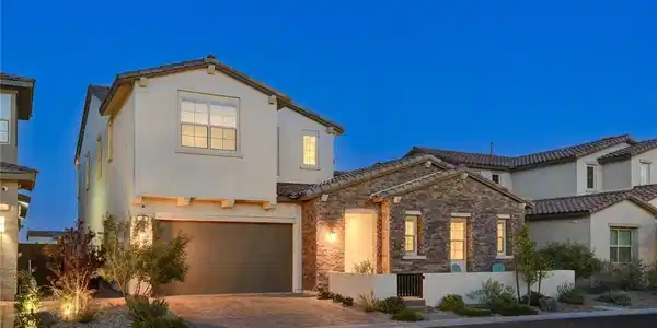 Image 3: Crafted with stucco and stone, this elegant home p