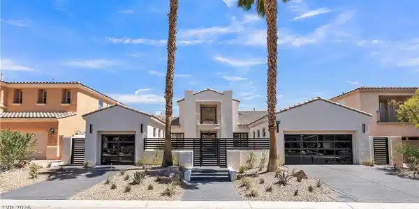 Image 2: Desert landscaping and towering palms frame the mo
