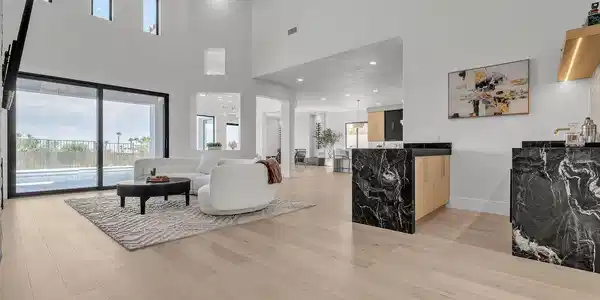 Image 4: High wood-clad ceilings and broad sliding glass do