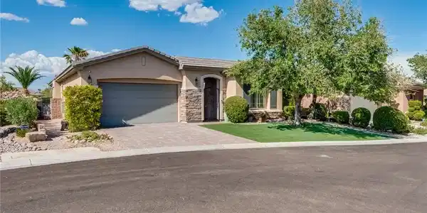 Image 3: Manicured landscaping and stone accents frame this