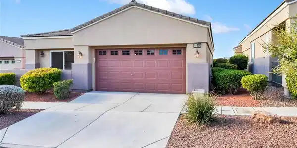 Image 3: Neat desert landscaping and a concrete driveway le