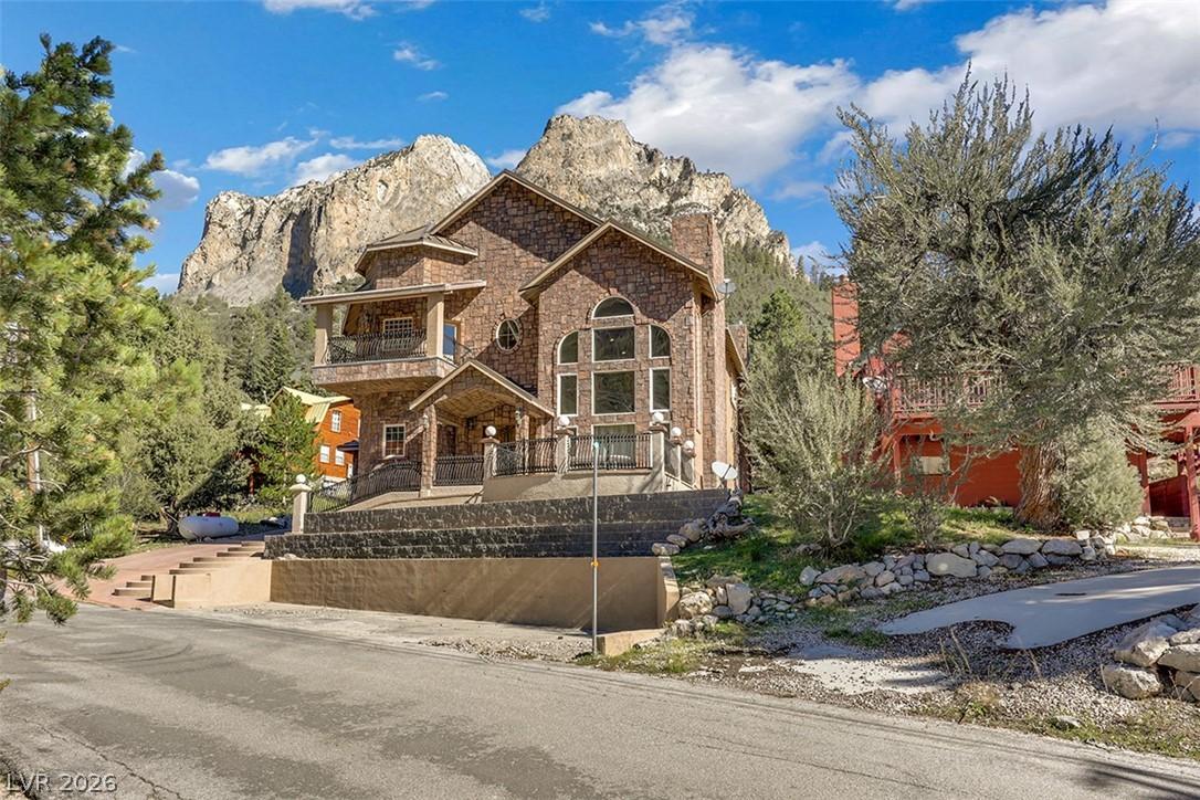 Image 4: This majestic stone-clad residence offers dramatic