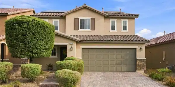 Image 4: An inviting two-story exterior showcases stucco wa