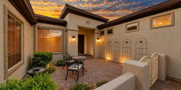 Image 2: A gated entry courtyard featuring pavers and stucc
