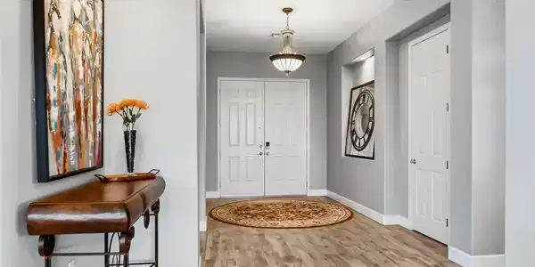 Image 3: A welcoming entryway with wood-look flooring leads