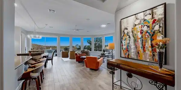 Image 4: Gleaming wood-look tile floors flow throughout thi
