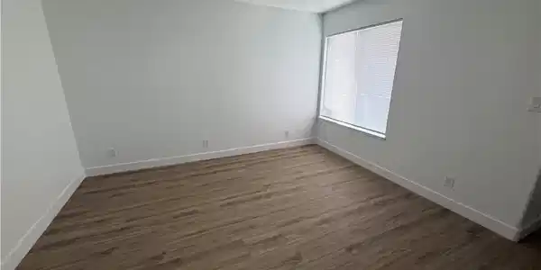 Image 2: Gleaming wood-inspired flooring pairs with crisp w