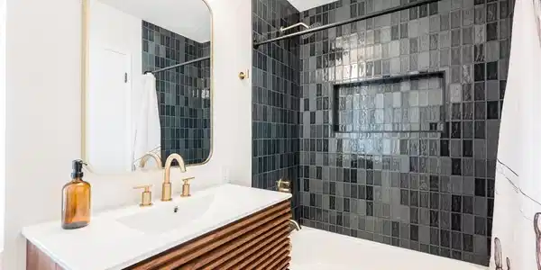 Image 3: A well-appointed bathroom offers sleek vanity, war