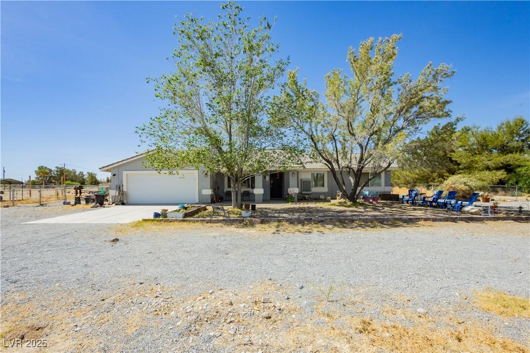 Image 3: Ranch-style house with an attached garage, stucco