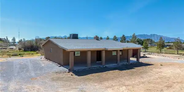 Image 3: Back of property with a mountain view and a chimne