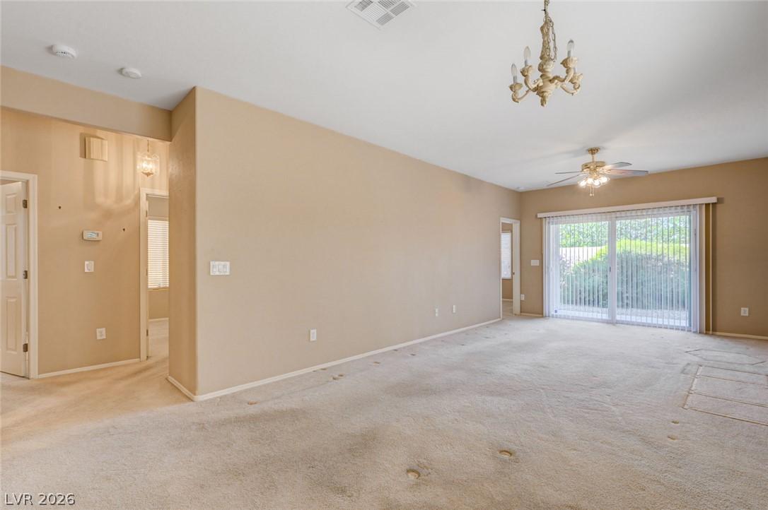 Image 2: A spacious living area with warm walls, plush carp