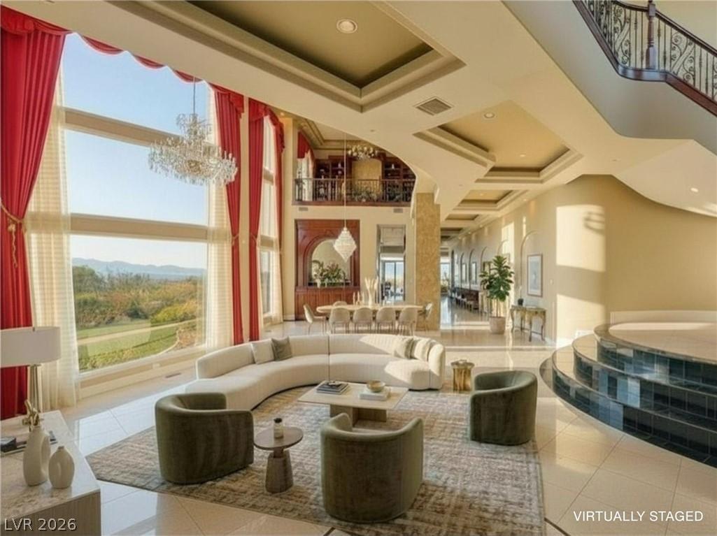 Image 4: Grand living area with towering windows overlookin