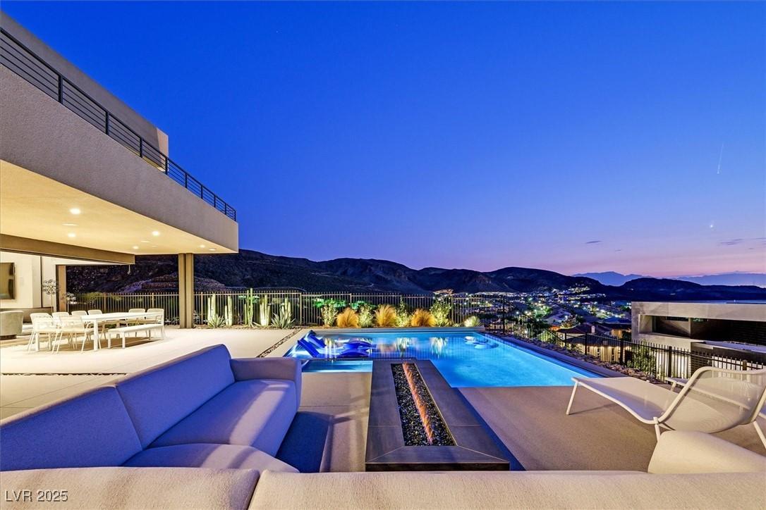 Image 3: View of pool with a mountain view, a patio, an out
