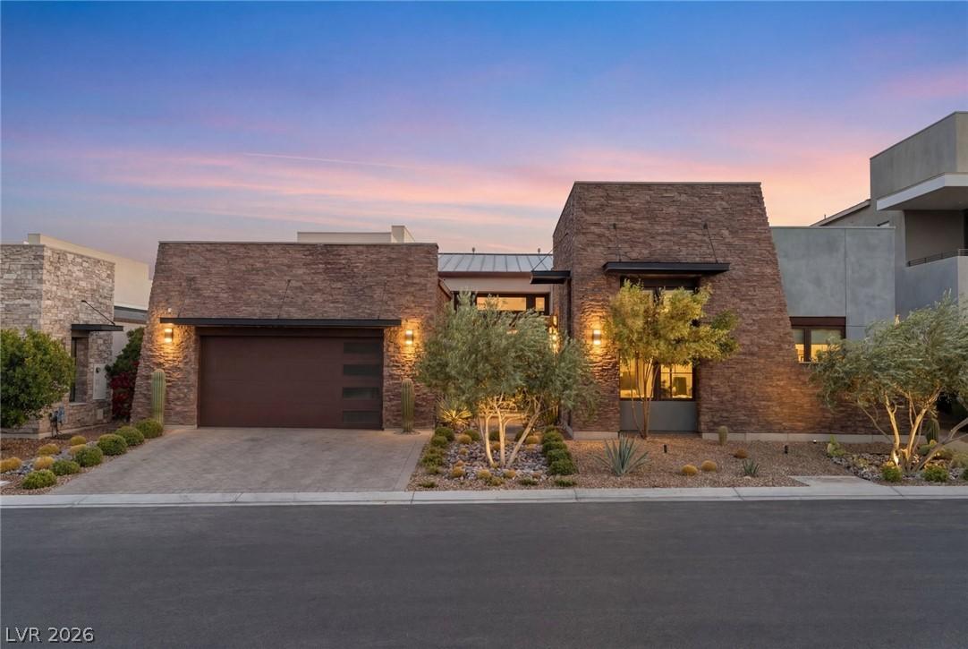 Image 3: A striking contemporary residence boasts stone acc