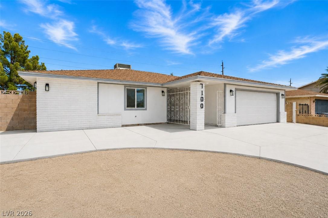 Image 3: A well-maintained facade with a broad driveway and