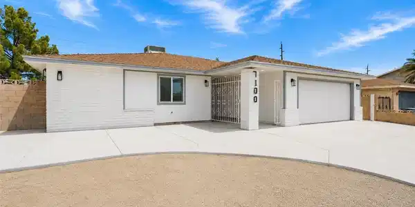 Image 3: A well-maintained facade with a broad driveway and