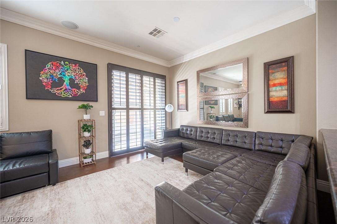 Image 4: Living area with dark wood finished floors and orn