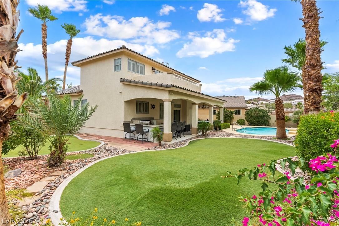 Image 2: Lush landscaping and a refreshing pool define this