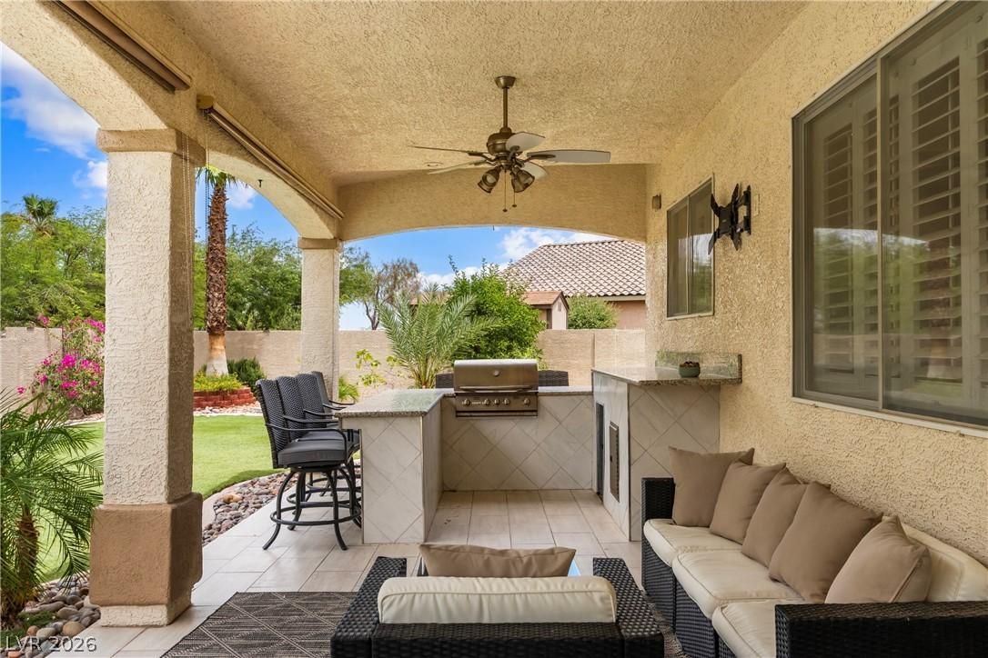 Image 3: An inviting outdoor living space features barbecue