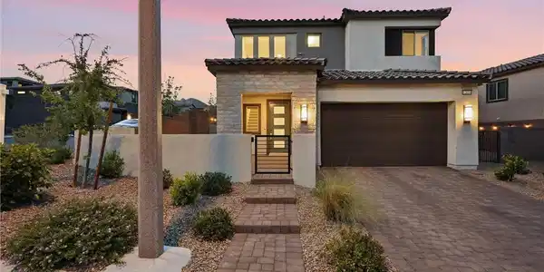 Image 2: A modern facade with a paver driveway and a charmi