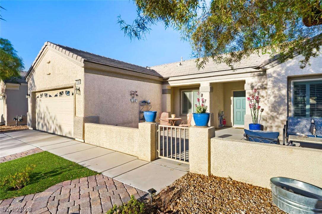 Image 2: A welcoming stucco facade with an attached garage