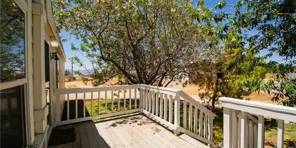 Image 2: A spacious wooden deck provides ample outdoor livi