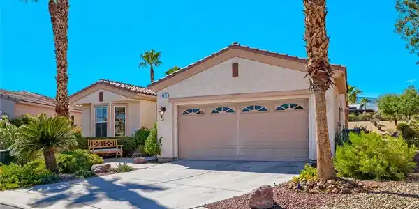 Image 4: Palm trees frame a concrete driveway leading to a
