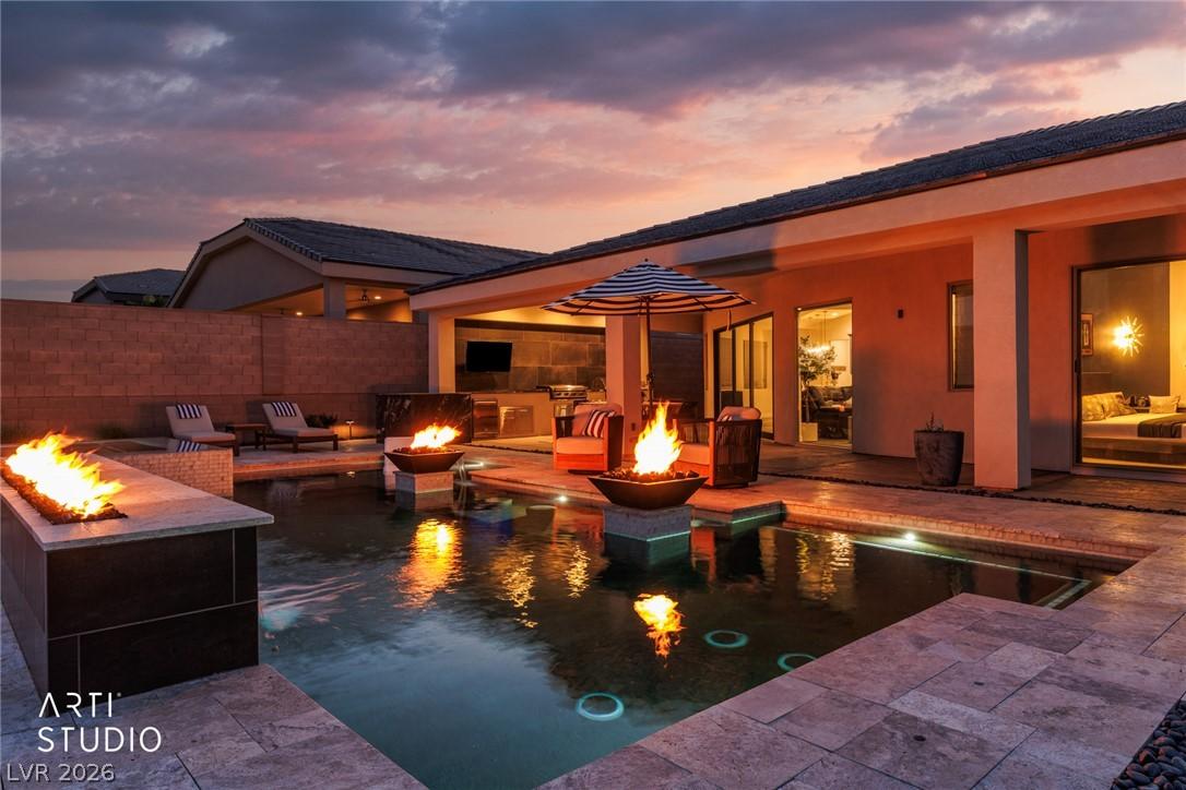Image 2: An inviting backyard oasis features a shimmering p