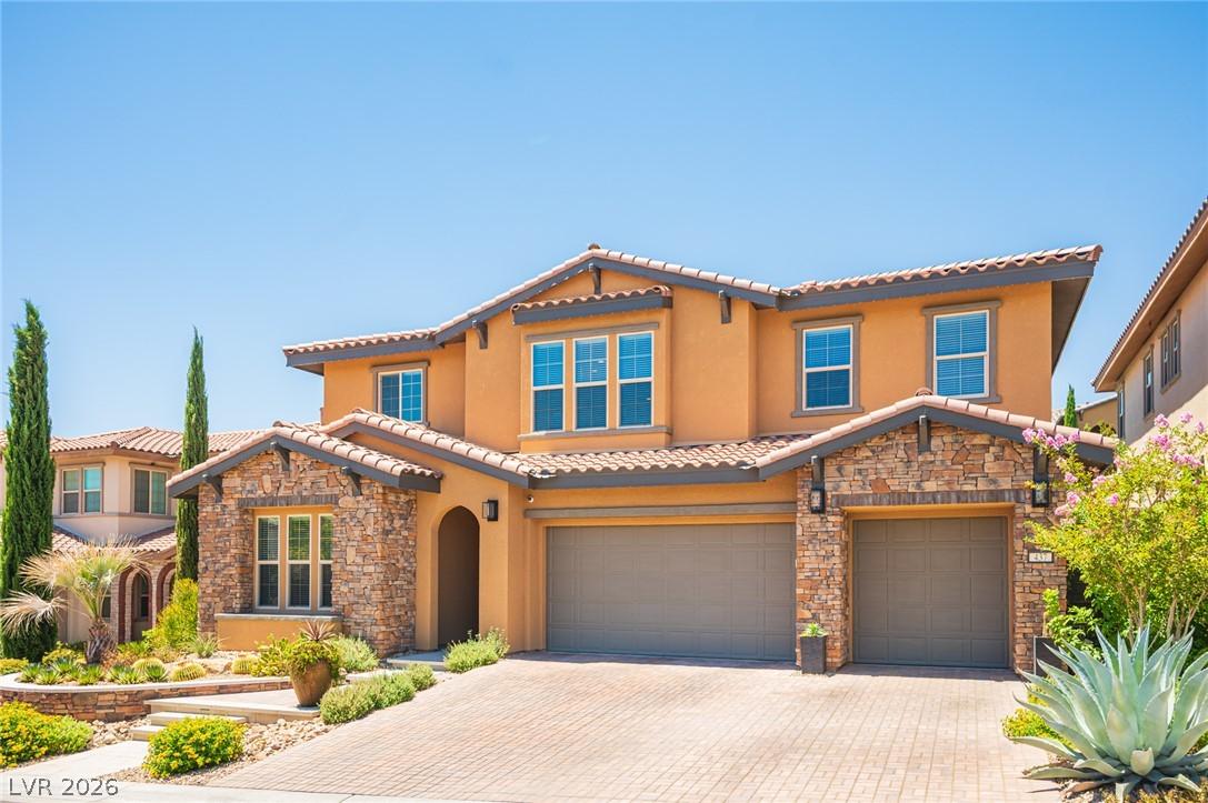 Image 1: A charming stucco exterior with stone accents and