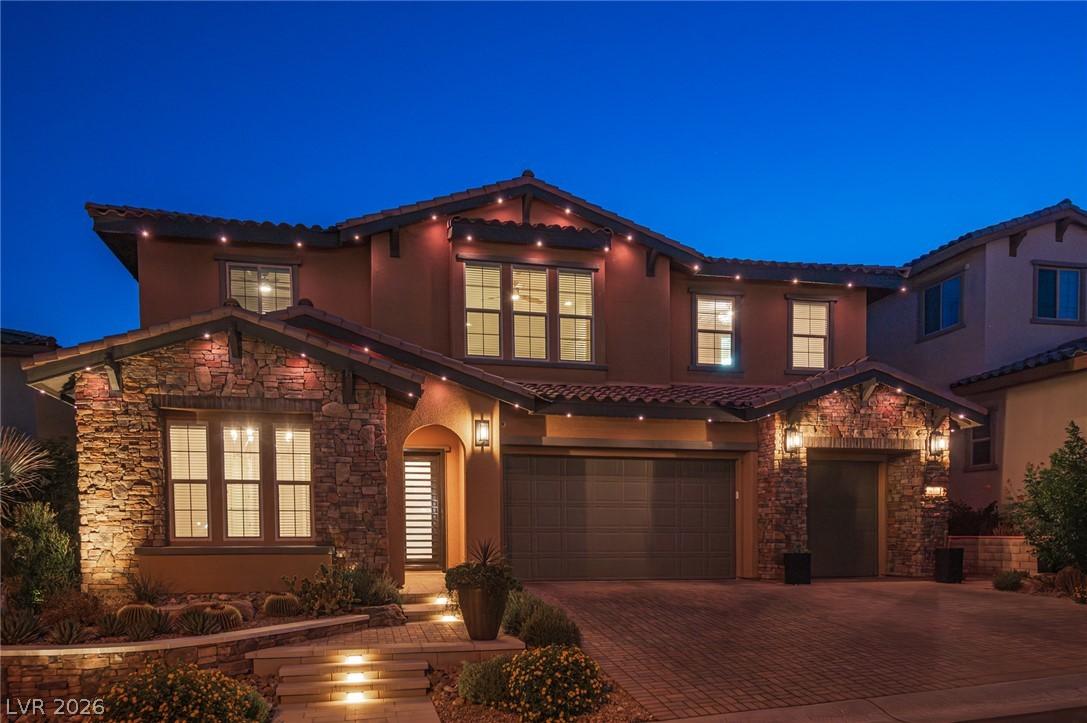 Image 3: Illuminated stone accents and desert landscaping d