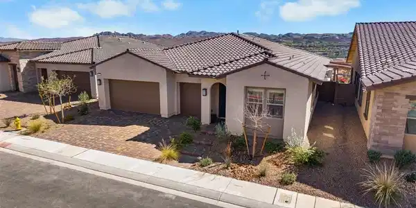 Image 3: View of front of house featuring a garage, stucco