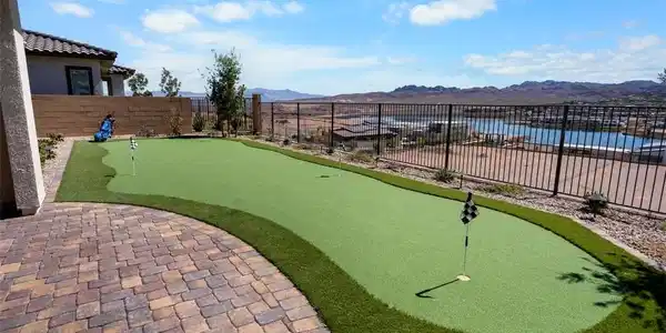 Image 4: Fenced yard featuring a putting area, a mountain v