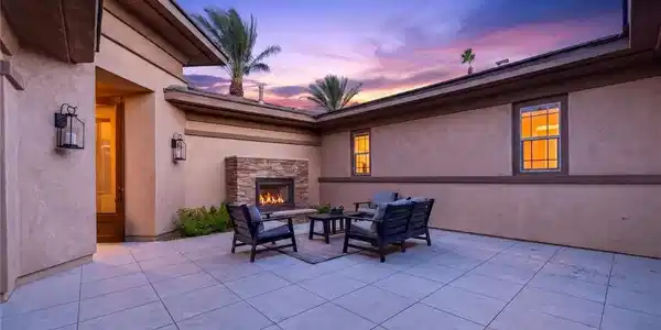 Image 2: An inviting stone fireplace anchors this paved 500