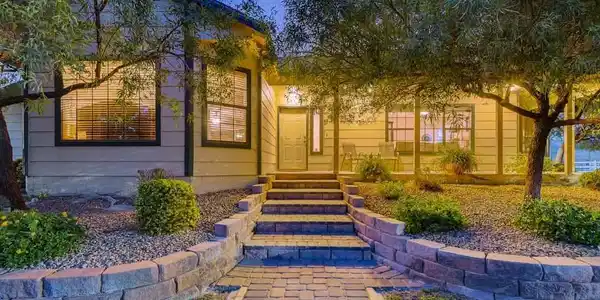 Image 2: Stone-paved steps and a winding walkway lead up to