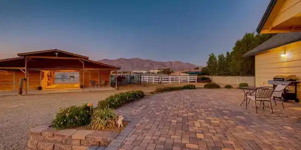 Image 3: An expansive brick paver patio overlooks the horse