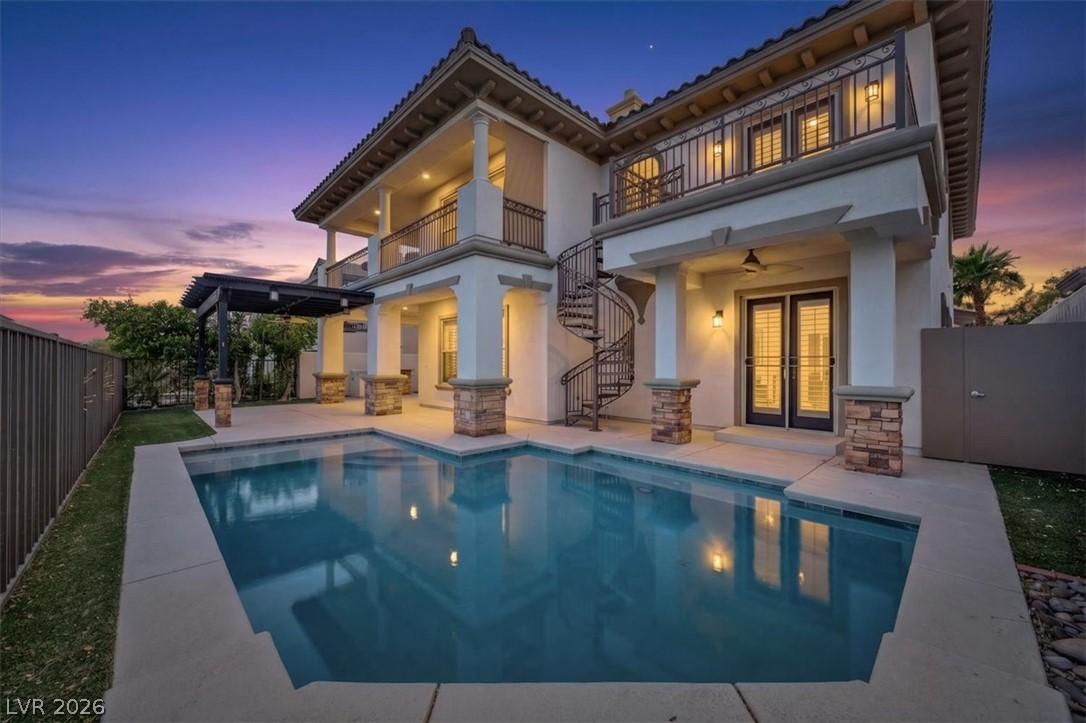 Image 3: An inviting backyard oasis offers a sparkling pool