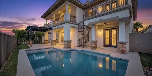Image 3: An inviting backyard oasis offers a sparkling pool