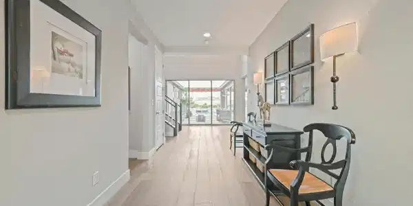 Image 2: An inviting entryway with wide plank flooring lead