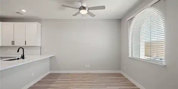 Image 4: Bright and open, this area combines modern kitchen