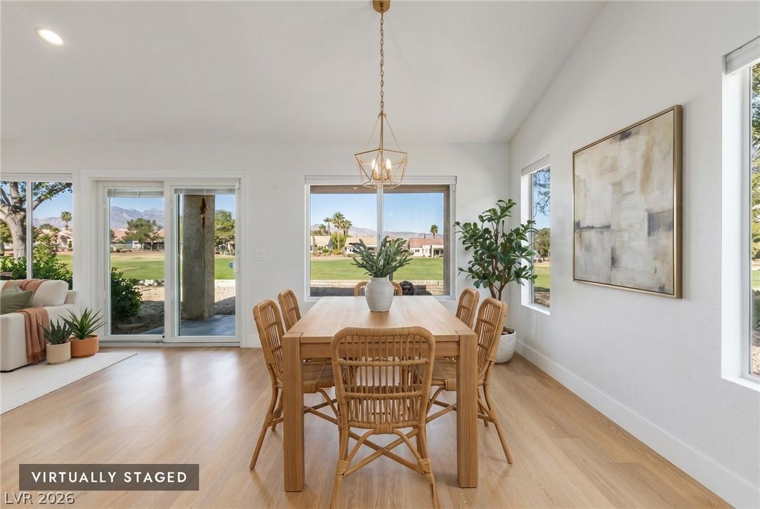 Image 4: A golf course backdrop enhances this dining area,