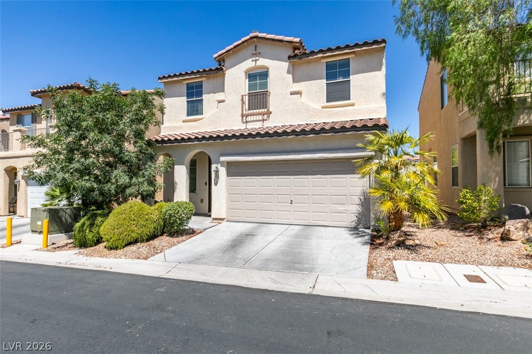 Image 2: A charming stucco home with a terracotta tile roof