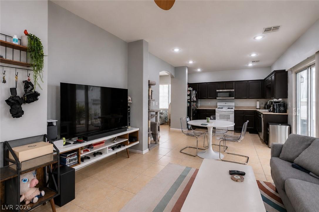 Image 4: An open concept living area features recessed ligh