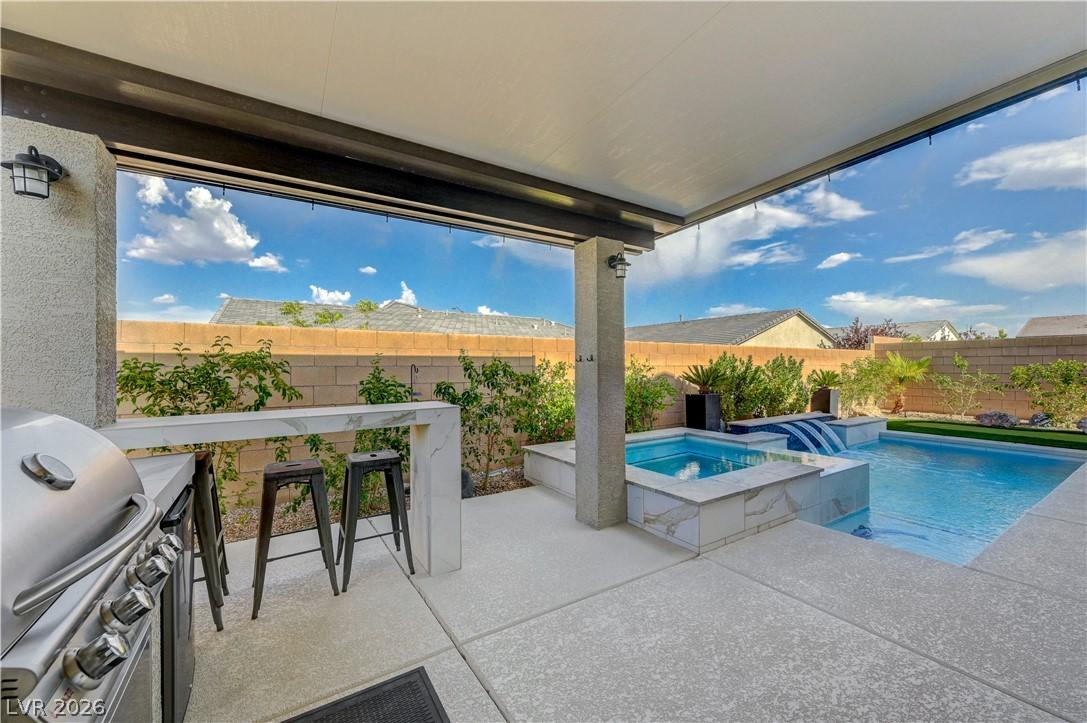 Image 1: An inviting outdoor space features a custom pool,