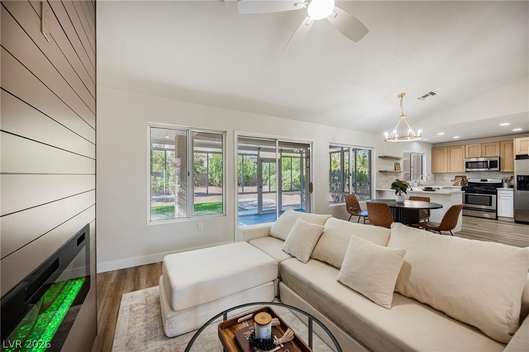 Image 2: An open concept living area boasts elegant floorin