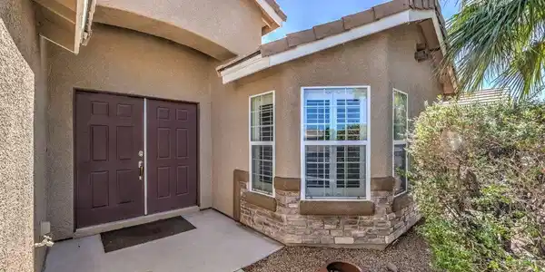 Image 2: Double entry doors and a bay window define this we