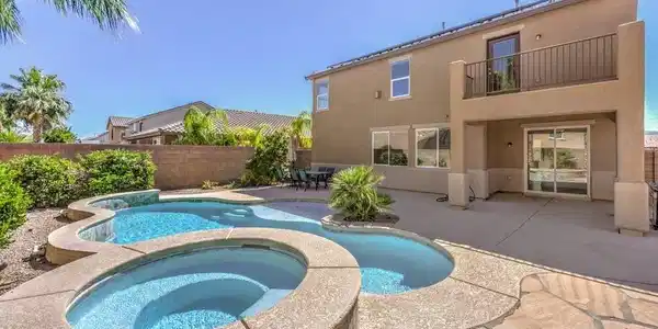 Image 2: This amazing backyard features a pool, spa, covere